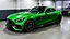 Placeholder: Mercedes-Benz AMG GT63s, green, with four side doors parked in a luxury garage, with the car facing right