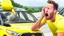 Placeholder: guy in hurricane arguing on phone next to his kia sportage made out of lemons