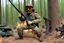 Placeholder: [1960’s stop-motion animation style in woods] a 70s rifle gun advertisement video TV featuring a crazy artist with black goggles brown curly hair and a grayish beard in combat fatigue holding a hunting rifle in front of his international scout automobile as a claymation character toy from a claymation horror movie in burning rainbow land, from hell, creepy Videos, eyeballs and trees everywhere , as old advertisement shot on video VHS