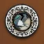 Placeholder: coaster of kingfisher ivory brooch with black pearl inlay, opalescent marble carving, decorative design, classical ornament, highly ornate, highly intricate, highly detailed etching, marble carving, warm lighting, linen backdrop