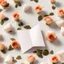 Placeholder: A photo of a white folded card, 5.5 by 4.25 inches. The card is vertically positioned on a beautiful white surface, positioned between rose petals and litte golden hearts.