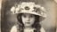 Placeholder: Vintage photograph of a young girl in a hat with flowers