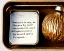 Placeholder: one acorn in tin box with note tied around