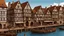 Placeholder: gothic medieval wooden harbour with piers and ships, people, shops, bridges, arches, balconies, taverns, blue sky, photorealistic