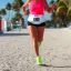 Placeholder: Sonia Lombardi running a marathon on Miami beach, about to cross the finish line, photo realistic, 8k, realism