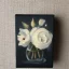 Placeholder: tiny oil painting of single long stem pressed flower, white canvas, moody, vintage, delicate arrangement, beautiful composition, etsy, aesthetic layout, plain solid white background