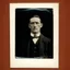 Placeholder: very grainy discolored photo, closeup portrait, dark night street, grunge, male with chalk-white skin, 1910's gentleman