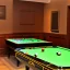 Placeholder: Circular pool table.