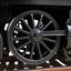 Placeholder: isolated image of a cast iron spoked steel wheel(black) from a steam train. vignette of just the wheel, photorealistic