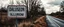 Placeholder: roadside sign warning about dangerous illusions and artwork in the road