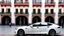 Placeholder: A Tesla's 'Model S Plaid' is parked, at the 'Plaza de la Constitución', in the city of Mexico. CINEMATIC. WIDE ANGLE LENS. PHOTO REAL.