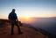 Placeholder: a brawny man with grey hair views sunset from a cliff