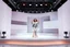 Placeholder: A 3D recursive structure modern stage with a pretty lady in modern clothing dancing,animating background stage