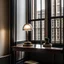 Placeholder: a table with a lamp in front of a window