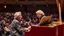 Placeholder: Two Elderly pensioners playing a duet together on a piano on a concert hall stage in front of a large audience. Photographic quality and detail, award-winning image, beautiful composition.