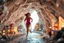 Placeholder: make a video pretty crystal cave covered with jewells and CIFI jewell lights and miniature city buildings and miniature people and streets, a beautiful fashion model lady with cute,curvy hair,makeup, in pretty sports suit is running inside cave ,dynamic camera fallow her inside cave capturing full body, dynamic lights.