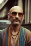 Placeholder: Hippie man with Parisian bohemian look and glasses of colours and poor hair on the head half part bald . Vintage look and feel like photos of the 70s