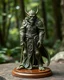 Placeholder: A tabletop role-playing miniature of an elf-half-orc-humanoid-ape-human cleric with flowing, minoan armour and robes with minoan patterns. The design blends elegant art nouveau curves, delicate leaf patterns, and fantasy elements, with a serene, wise expression and finely detailed, elven features. Art in the style of Alan lee, john howe, Richard and wendy pini, Michael whelan, william morris and art nouveau. the creature is full body and stands on a wooden base. the background is a forest.