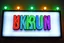 Placeholder: A 1980 disco sign labeled "KUKRUNK" white background and bold multi colored 80s font, miami vice