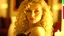 Placeholder: Closeup of a beautiful 17 year old caucasian girl with long curly blonde hair. She is wearing a black lace bustier with red ribbons. She is in a candlelit bedroom near a window. She is gazing at the viewer.