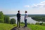 Placeholder: An image of two people exchanging criticism in a constructive and respectful manner, standing on a hill with a lake behind them 4K