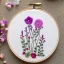 Placeholder: embroidery hoop with delicate embroidery and beadwork of flowers, pressed flowers, tulle, couture, beautiful composition, aesthetic layout, wildflowers, detailed beadwork, beading