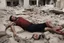 Placeholder: Bloody Man with no legs lying in ruins in Gaza