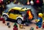 Placeholder: A crying toddler takes a burning car out of a LEGO box marked Land Rover next to the Christmas tree.