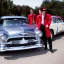 Placeholder: a 50s Greaser ROCK BAND standing in front of a hot rod