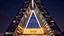 Placeholder: Skyscraper shaped like the letter 'A', with steel diagonal beams and a massive triangular atrium at its core, glowing at night.