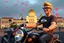 Placeholder: 3D video game characters, a short blonde haired man wearing eyeglasses, t-shirts and jeans riding a motorcycle , Hungary, Budapest, Parliament, hearts, happiness