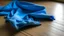 Placeholder: a torn very small blue cloth on the floor