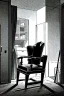 Placeholder: chair in the middle of an empty room, grayscale