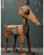 Placeholder: Illustration, comical dog created with disconnected shapes, shapes composed of flat rusted distressed metal panels. long irregular scalene triangle for head with oddly shaped ears, long neck connecting triangle head to oval body, with four legs and paws attached to body. A large rusted gear for the tail. whimsical, steampunk, dark distressed background.