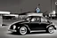 Placeholder: Digital Photo, 1950s, perfect perspective, night scene, a black Volkswagen beetle in front of a gas station pump, hyper realistic, hyper detailed, intricated, Frank Lloyd Wright