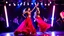 Placeholder: beautiful spanish dancers group dancing in luxury night club with dynamic lights