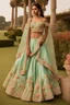 Placeholder: A mint green silk lehenga adorned with 3D floral appliqués and beadwork.The choli (blouse) features a modern off-shoulder design with delicate lace sleeves.The lehenga's flare is voluminous and creates a sense of grandeur.