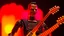 Placeholder: 4K portrait of the real-life. Maximum details. Terminator robot playing guitar, firestarter, radio broadcast logo, flames in the background. Radio hard rock