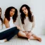 Placeholder: three girl posing, one seated, one standing, one seated on the floor, in a white room. photo shoot, new york flat, golden hour, cute beatiful, models,white hairs