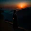 Placeholder: dark night, watching a woman from behind wearing a sleeveless dress who is watching a beautiful orange sunrise in the distance, mountains and forests around