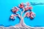 Placeholder: plasticine relief tall one alone almond tree blossom abstract with busy white pink and coral flowers and light blue sky