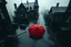 Placeholder: top-down view of a grayscale wet city street with old tall haunted houses, rain, one red umbrella lies down lying prone on the street, surreal style, dark mood