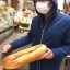 Placeholder: french guy in mask staring at a baguette lovingly