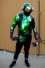 Placeholder: Metallic Cyber-punk style man with a web-camera-mask and old AKG-style headphones with golden rings. Large fencing mask covers man's cheeks. Man in good body shape. Reflective plastic body jacket full-coverage. Body and head full of integrated old-fashioned cameras and an old telephone. Black to army green latex surfaces body. Perfect body. Euclidean 3D-tiling, Escher tiling, background. Cables in head. Daft Punk 1996. Matrix black leather jacket with a Hood.