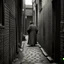 Placeholder: A mysterious 1800s figure in an alleyway