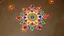 Placeholder: center view of a colorful Rangoli on a earthy rustic floor-surface with lots of diya surrounding the rangoli.