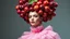 Placeholder: High fashion photography of a model in a Tim Walker and Alexander McQueen style pink plum dress, studio lighting, large-scale headdress with many fruits, wide shot, highly detailed, hyperrealistic, cinematic photography - ar 9:16. High fashion photo shoot of a model in a Tim Walker style pink plum dress, intricate headdress made of conceptual plum fruit sculptures