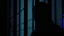 Placeholder: close up parallel prison window bars in foreground, dark prison cell behind them, hidden dark human face partially visible through the window bars, pale light, shadows in background, ultra realistic, dark atmosphere, high contrast shadows, dark vibe