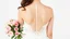 Placeholder: Back view of a bride in a white wedding dress facing forward in a bust with a bouquet of pink roses in her left hand on a white background