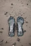 Placeholder: A toes looks dirty filled on the grey , Sands and dirt on a sands ground, view from the top, Bosch painting style